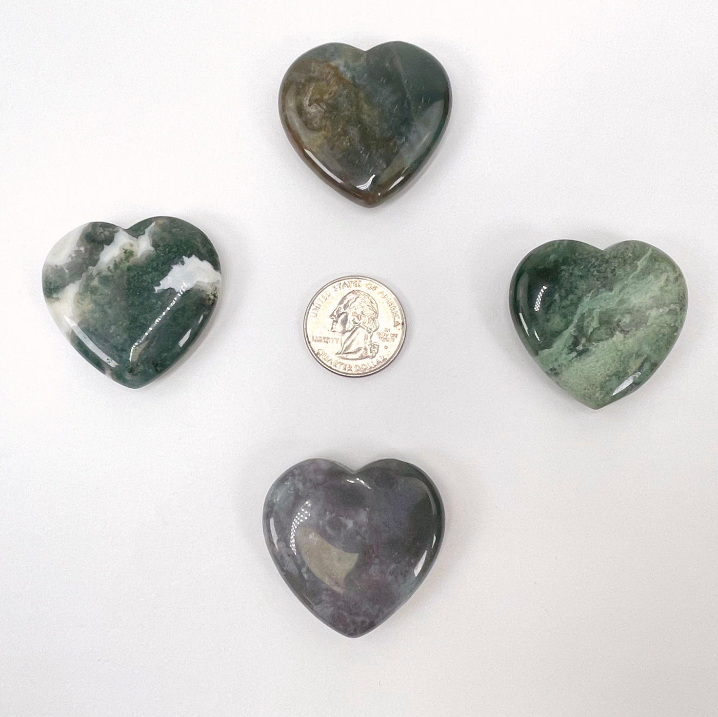 moss agate polished hearts with quarter for size reference