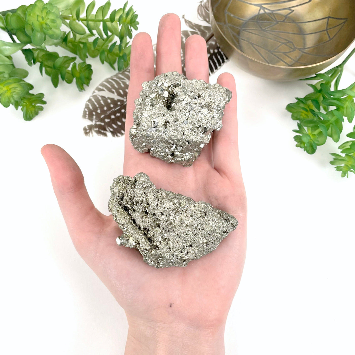 rough pyrite stone 2pc set in hand for approximate size reference