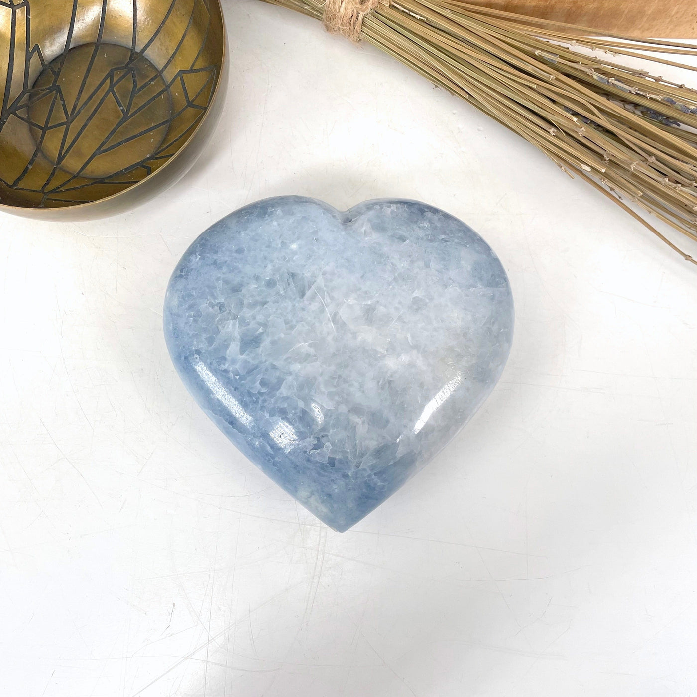 blue calcite polished heart laying flat in front of backdrop
