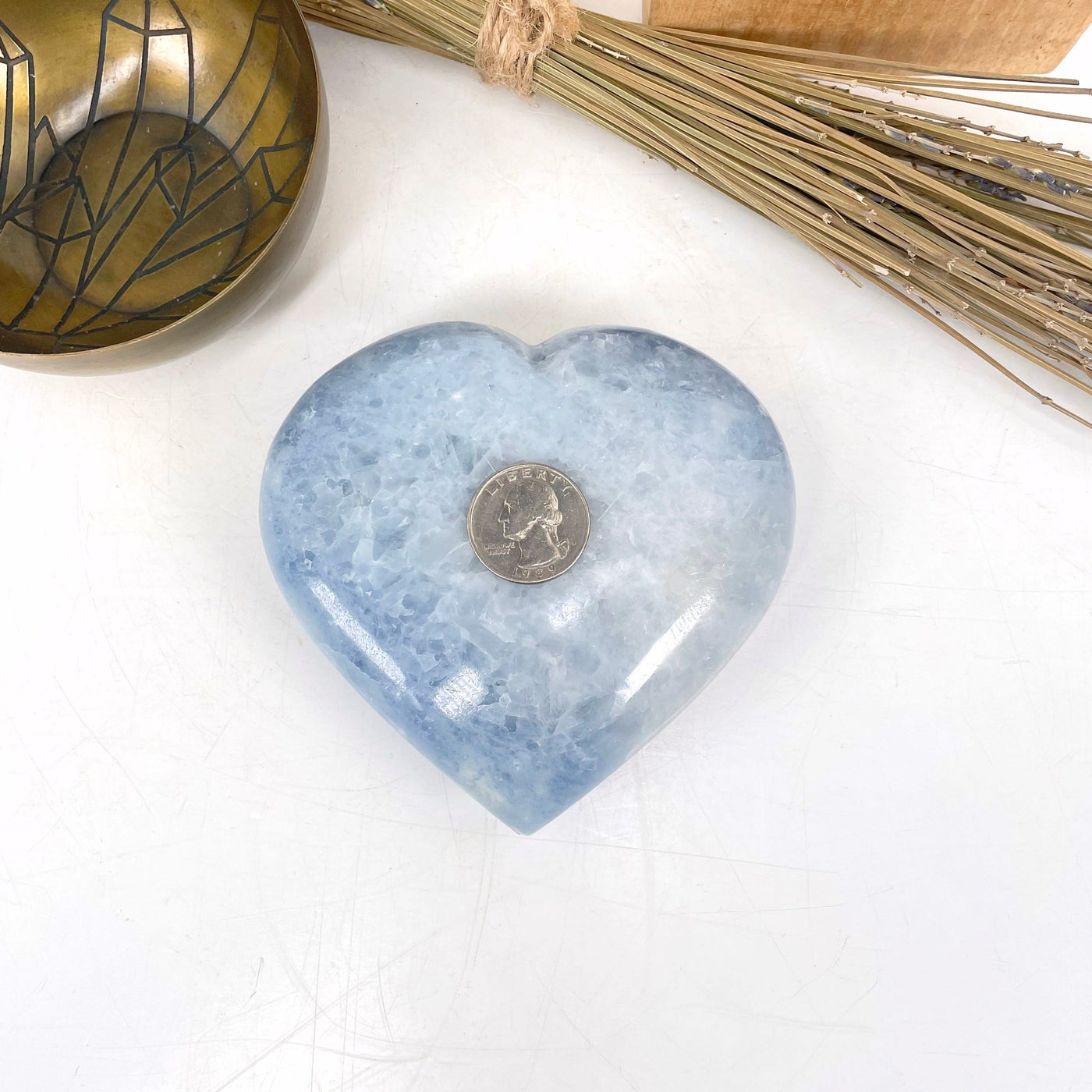 blue calcite polished heart with quarter for size reference