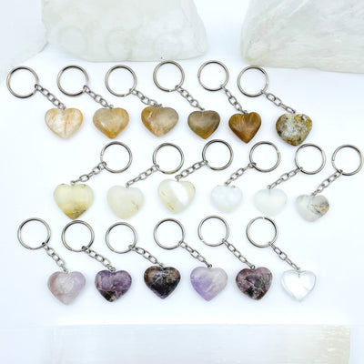  gemstone heart keychains with silver links and ring come in Yellow Quartz Heart Amethyst Heart Dendrite Opal Heart displayed to show character variations