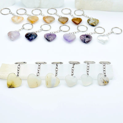 Dendrite opal heart keychain displayed to show variations in color and size
