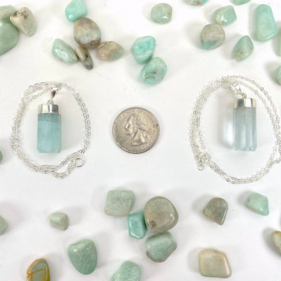 aquamarine pendant necklaces with quarter for size reference