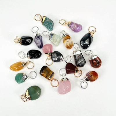 multiple stone pendants displayed next to each other to show the differences in the stone types 
