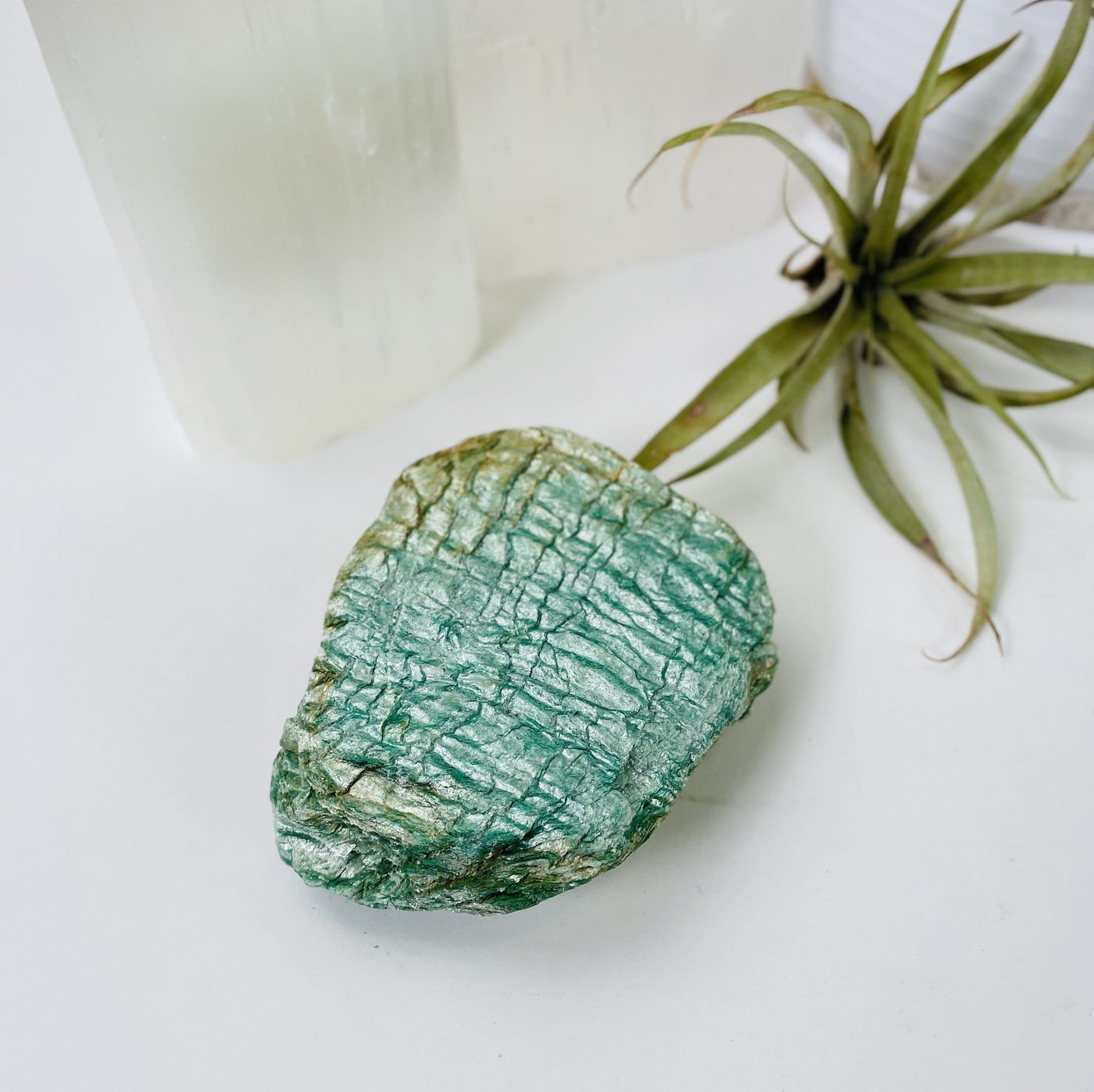 up close shot of Fuchsite Free Form with decorations in the background