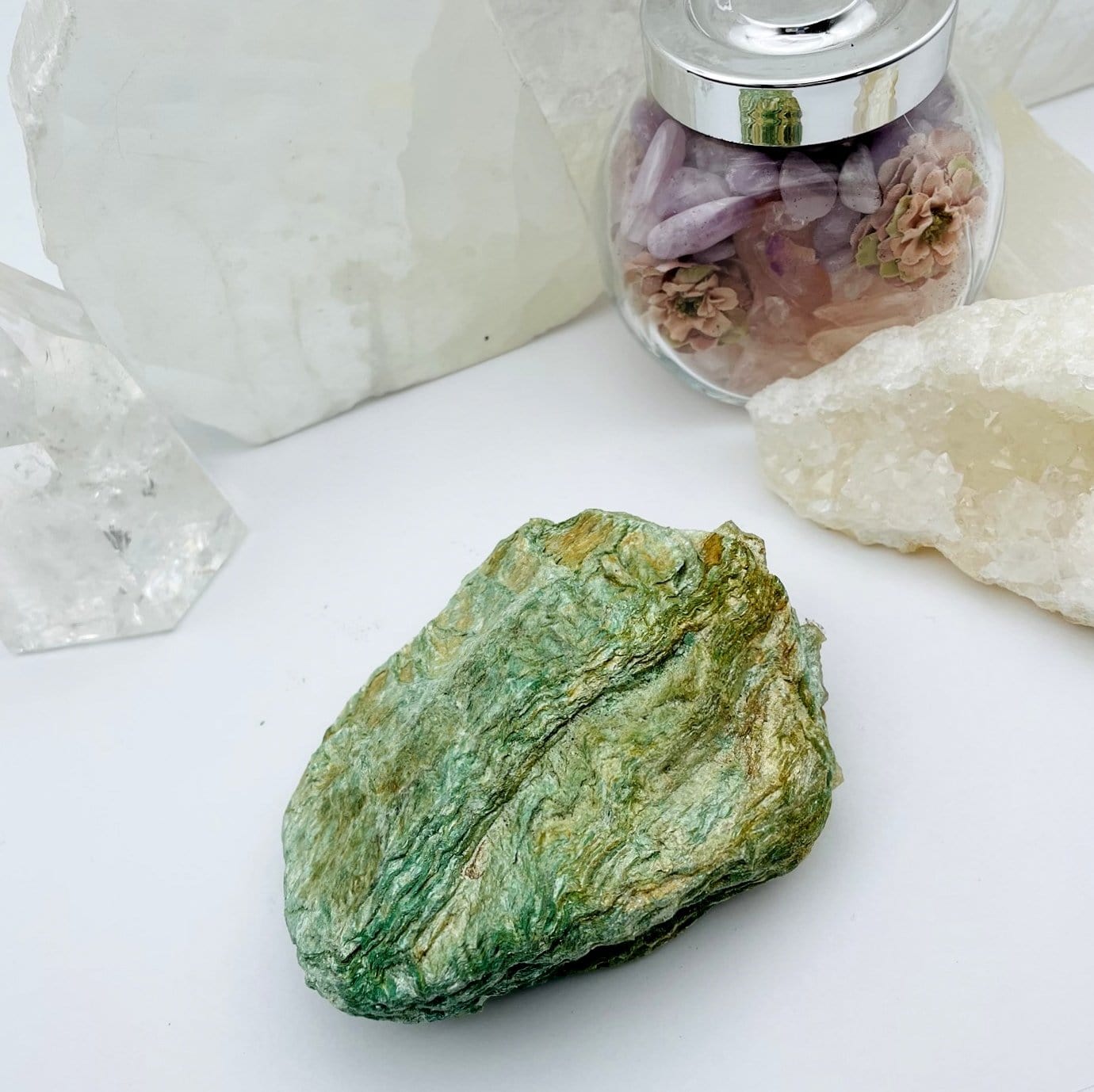 Fuchsite Free Form with decorations in the background