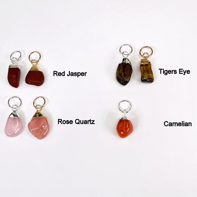 tumbled stones shown in gold and silver next to their stone names. available in red jasper, rose quartz, tigers eye and carnelian  