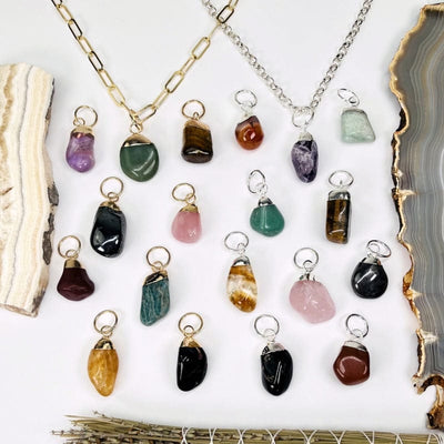 all the tumbled stone pendants displayed to show the differences in the stone types