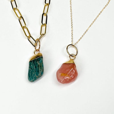 pendant displayed with a thick and thin chain showing that it can fit multiple sizes of chains 