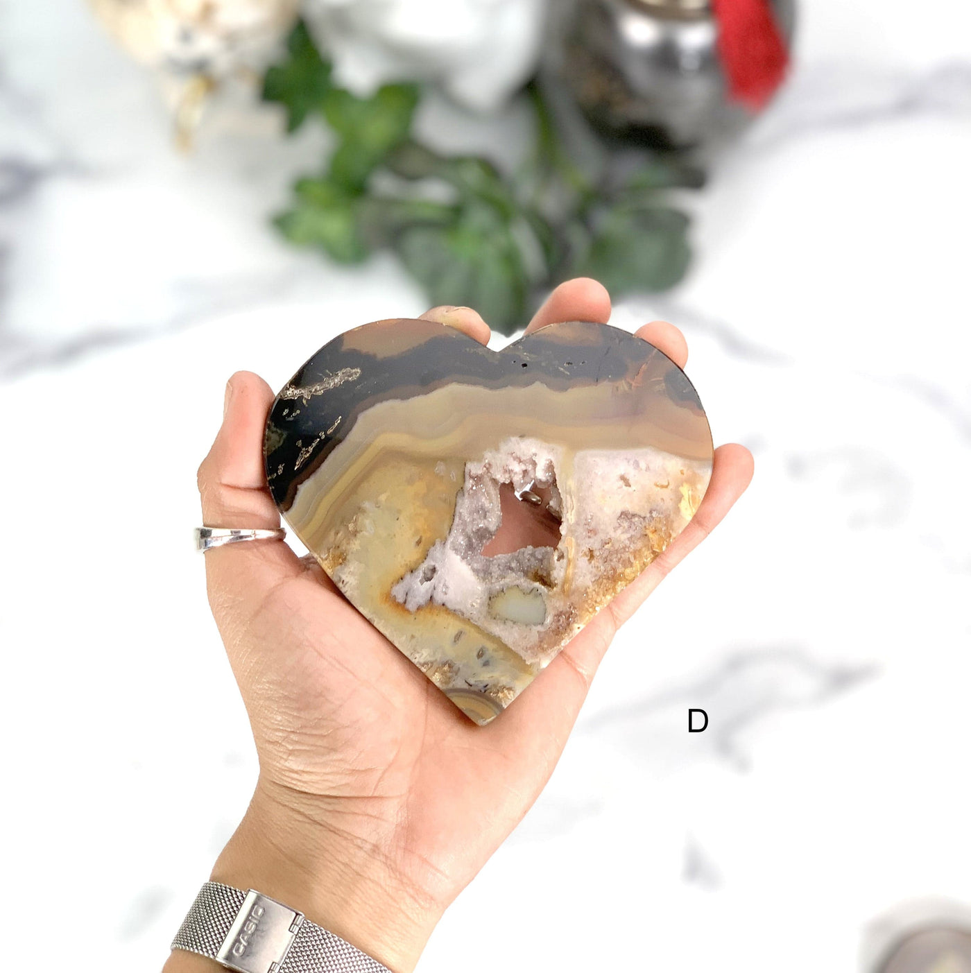Hand holding the front side of the Natural Agate Heart (D)