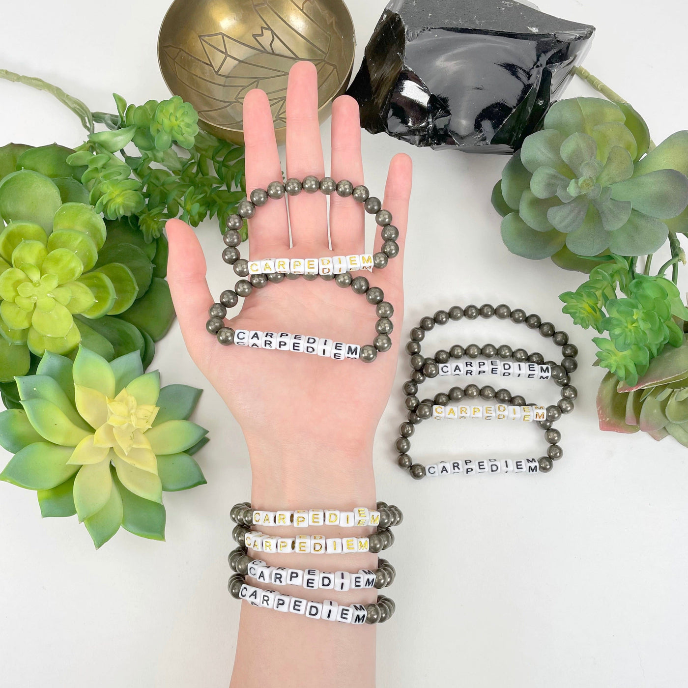 pyrite beaded bracelet in hand and on wrist with display