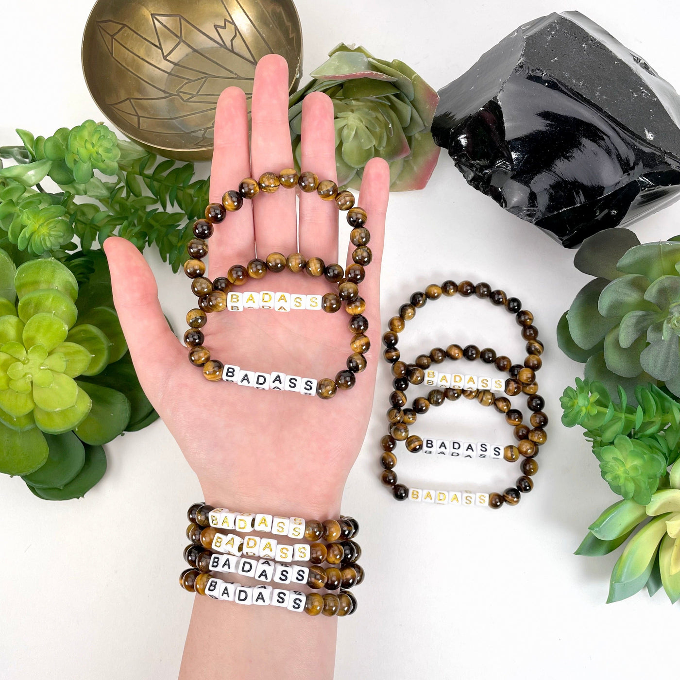 tiger eye beaded bracelet in hand and on wrist with display
