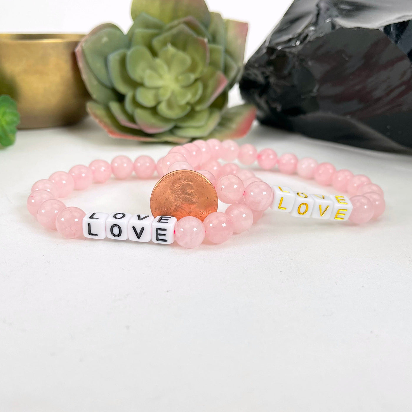 rose quartz beaded bracelets with penny for size reference
