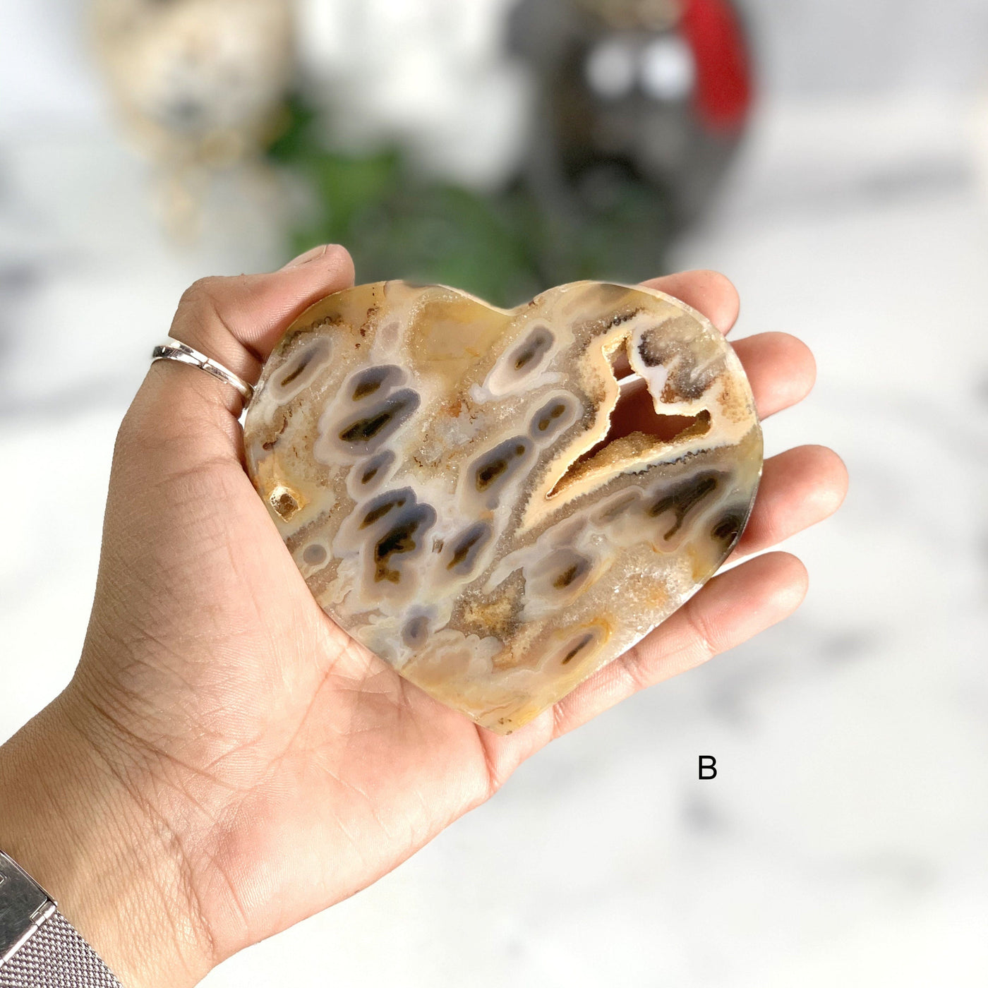 Hand holding the frontside of the Natural Agate Heart(B)