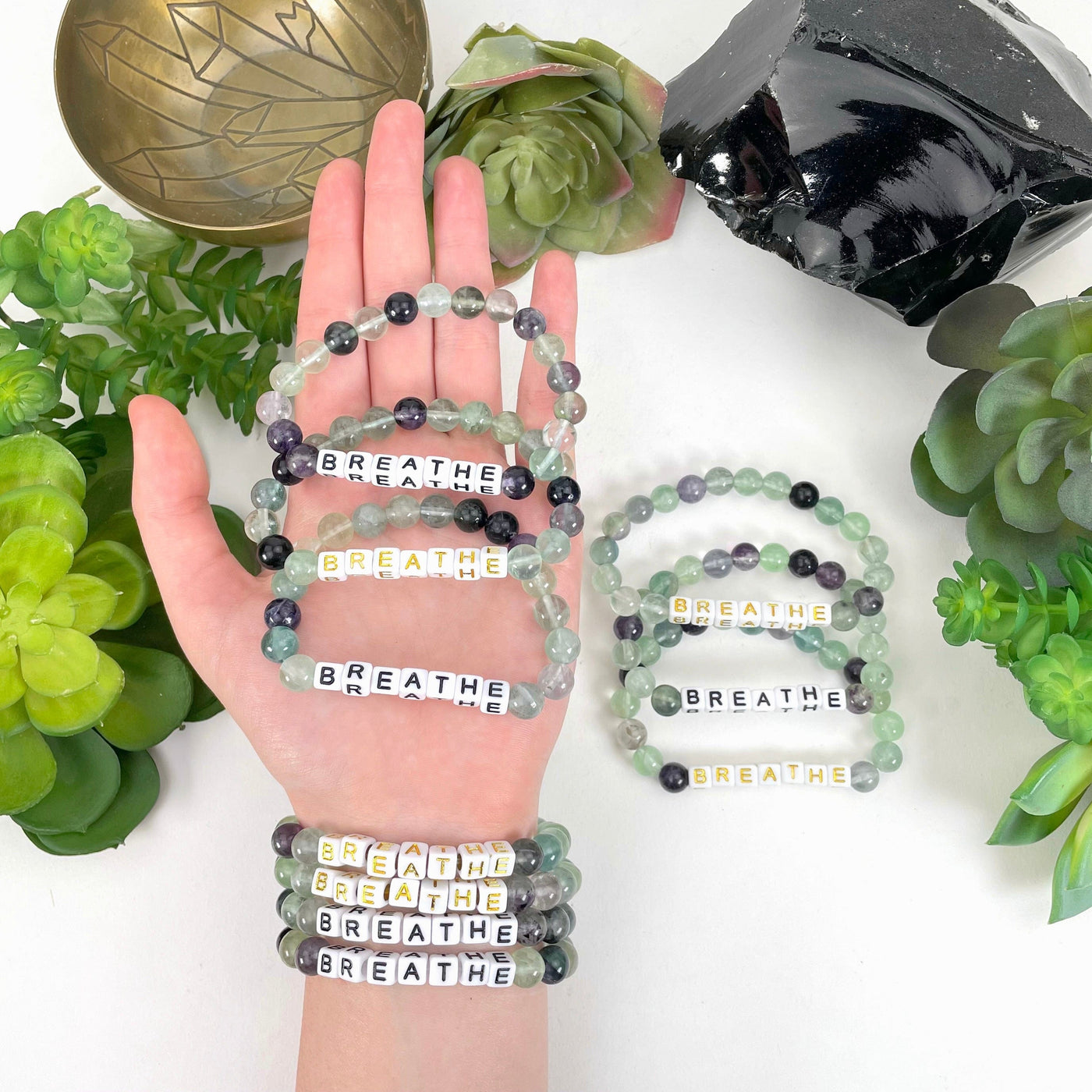 fluorite beaded bracelets in hand and on wrist with display