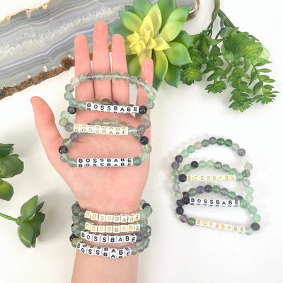 fluorite beaded bracelets in hand and on wrist with display