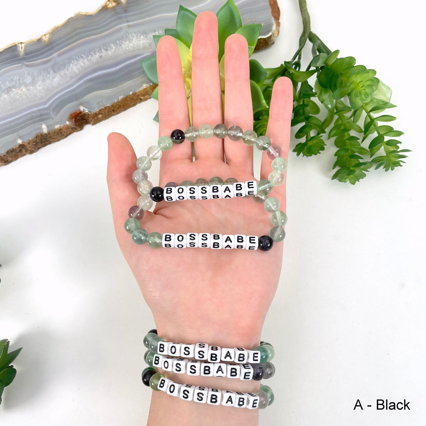 black "BOSSBABE" letter bead option in hand and on wrist for color reference