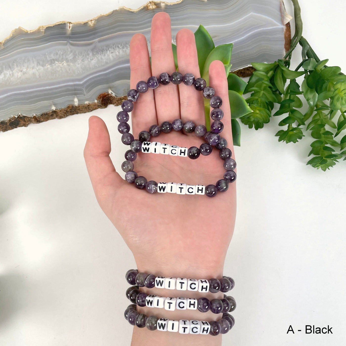 black "WITCH" letter bead option in hand and on wristt