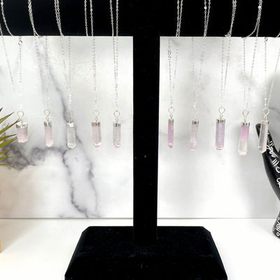 all pink kunzite necklace options hanging on display