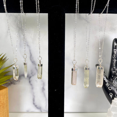 all kunzite necklace options hanging on display