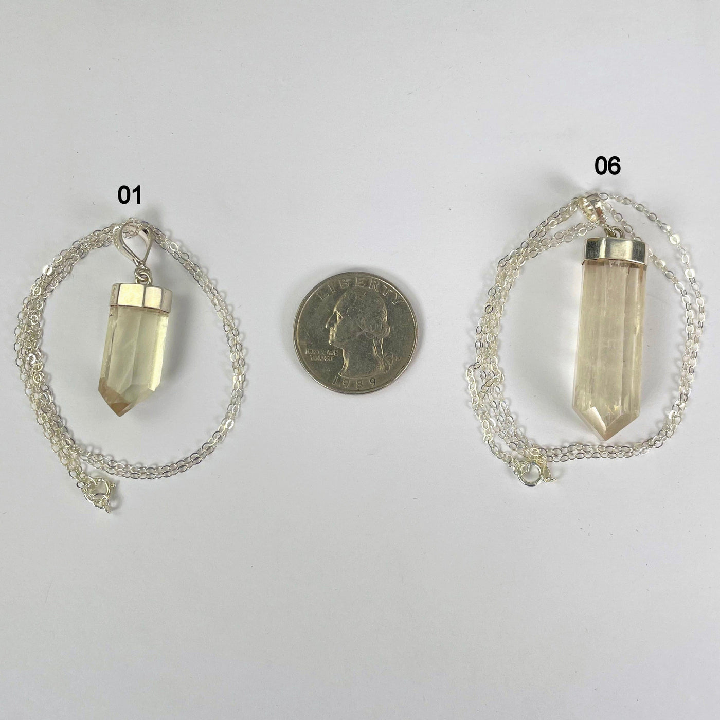 kunzite necklace options 01 and 06 (smallest and biggest) with quarter for size reference