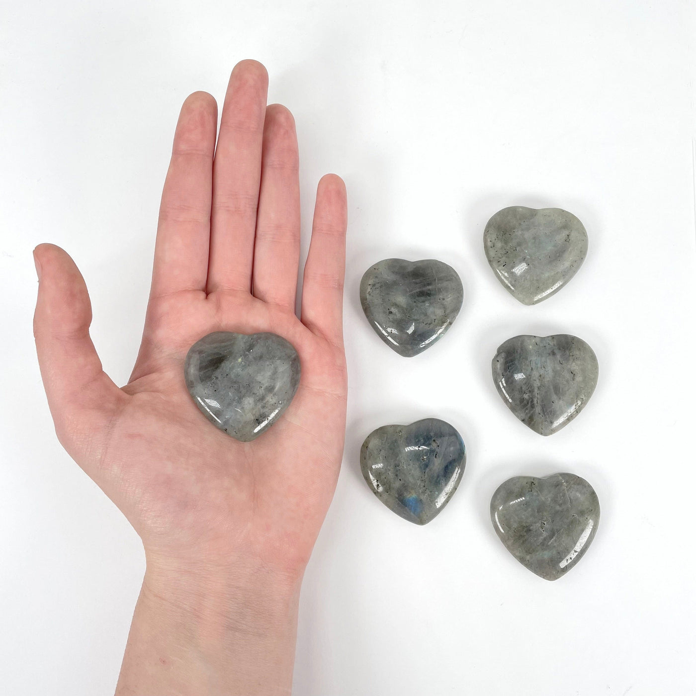 one labradorite polished heart in hand for size reference