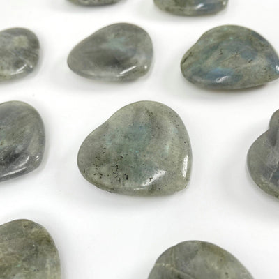 angled view of labradorite polished hearts for thickness