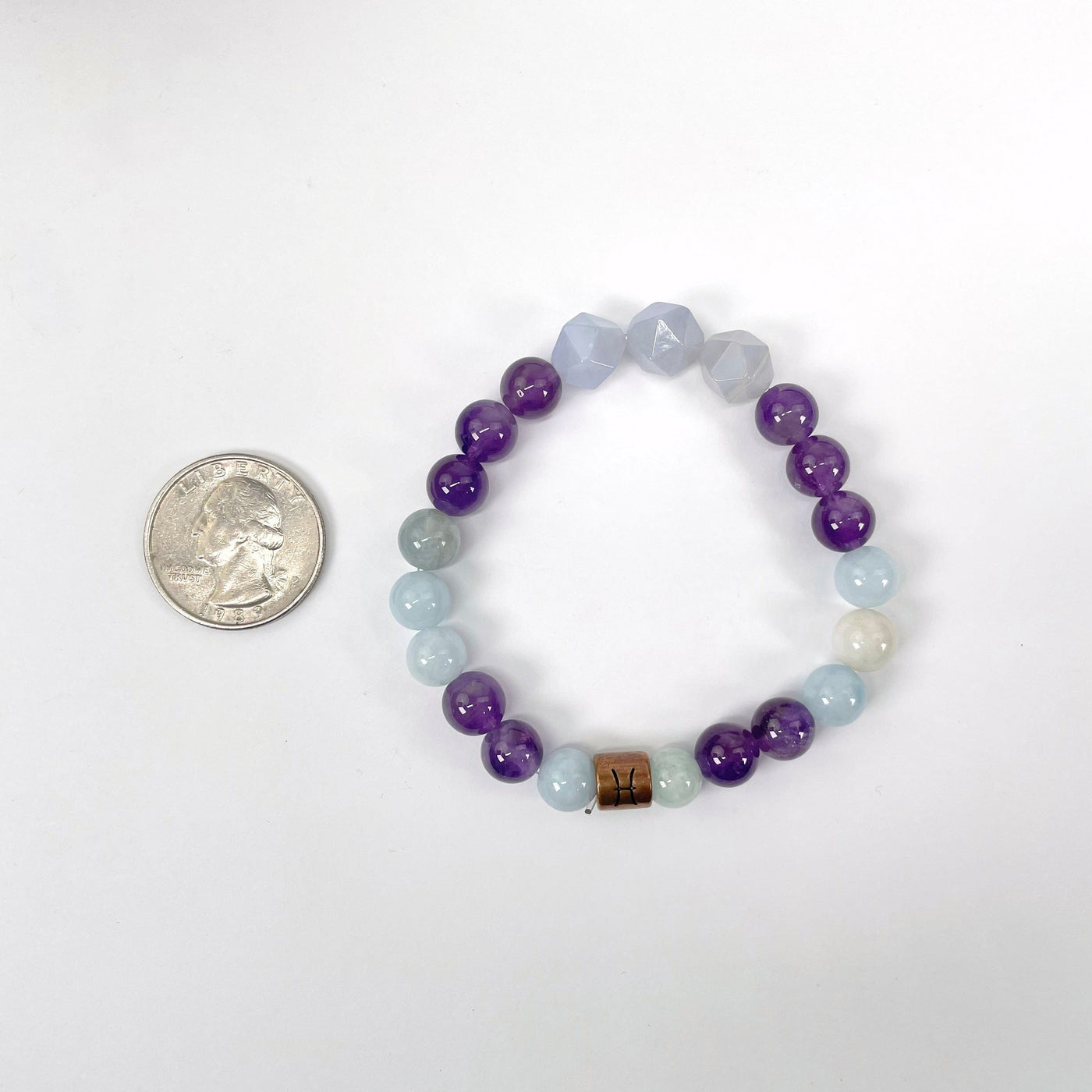 pisces zodiac bracelet with quarter for size reference