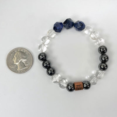 gemini zodiac bracelet with quarter for size reference