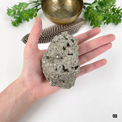 rough pyrite stone option 02 in hand for size reference
