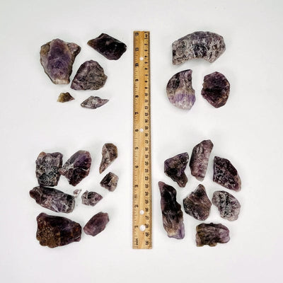 stones grouped together next to a ruler for size reference  