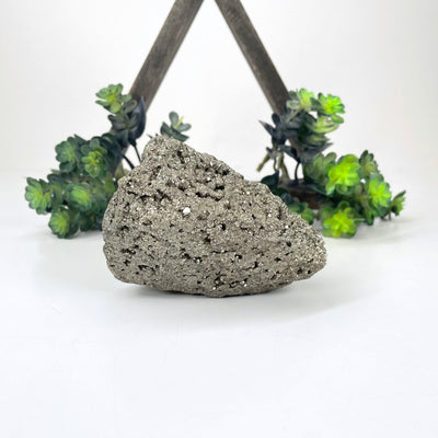 rough pyrite stone in front of backdrop