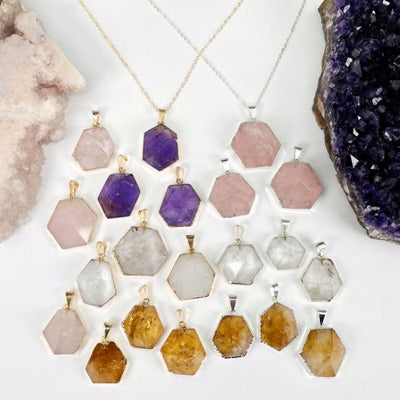 hexagon point pendants displayed to show the differences in the sizes and crystal types 