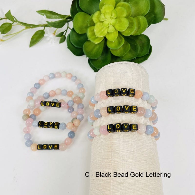 morganite bracelets available with black beads and gold letter 