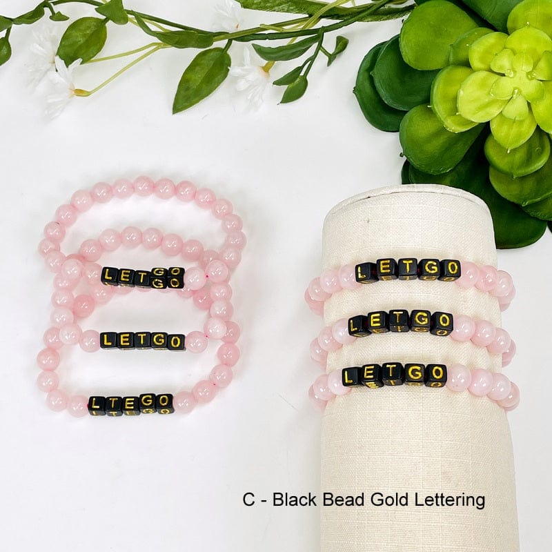 rose quartz round bead bracelets with black square beads spelling out LETGO in gold