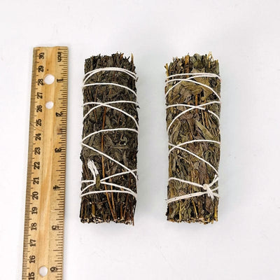 2 mugwort smudge bundles next to ruler for size reference