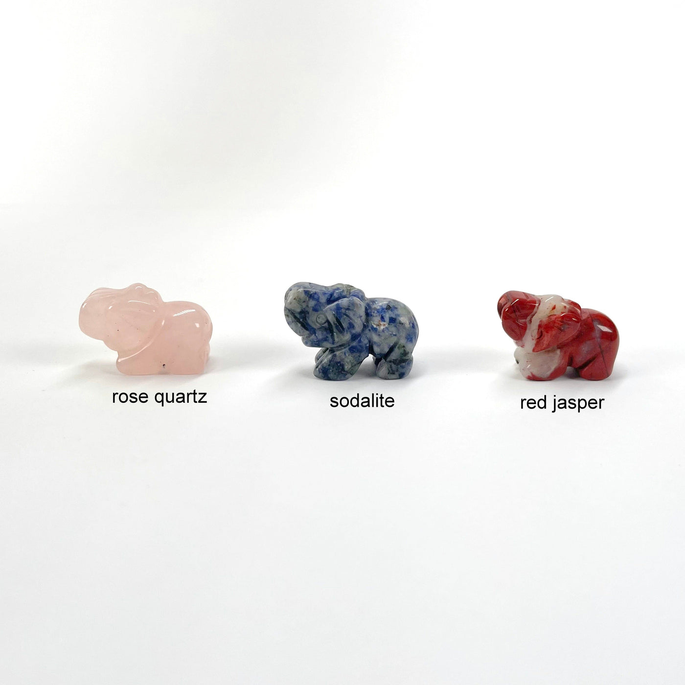 rose quartz, sodalite, and red jasper gemstone elephant options on display 