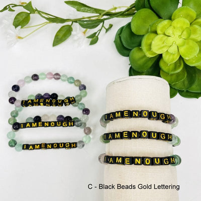 fluorite bead bracelet with black square beads that spell out IAMENOUGH in gold 
