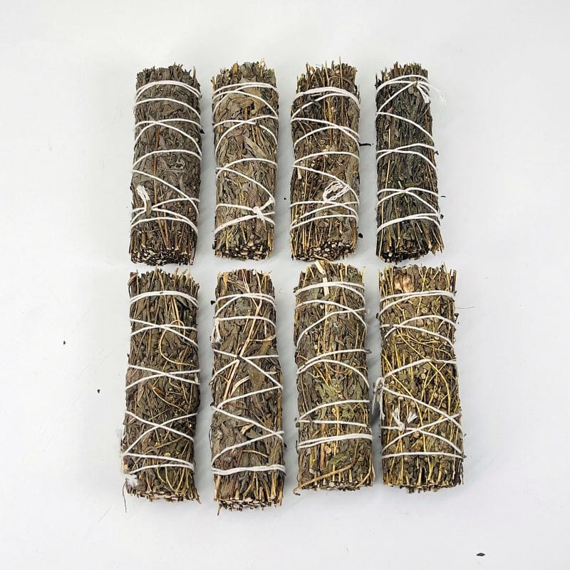 8 mugwort smudge bundles lined up on white background