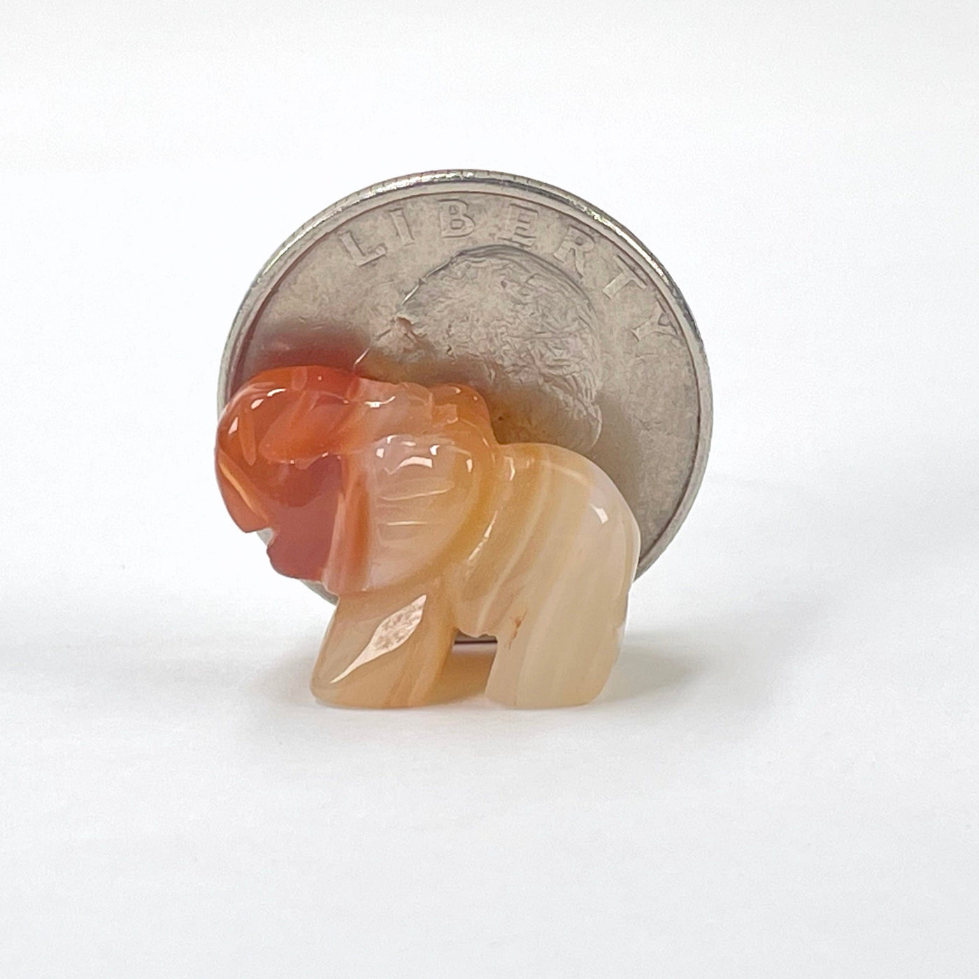 close up of gemstone elephant with quarter for size reference