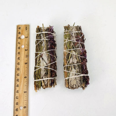 sage, lavender and rosemary bundles next to a ruler for size reference 