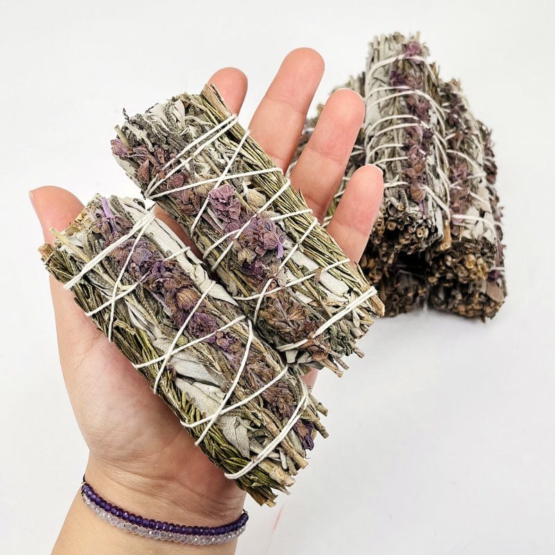 sage, lavender and rosemary bundles in hand for size reference 