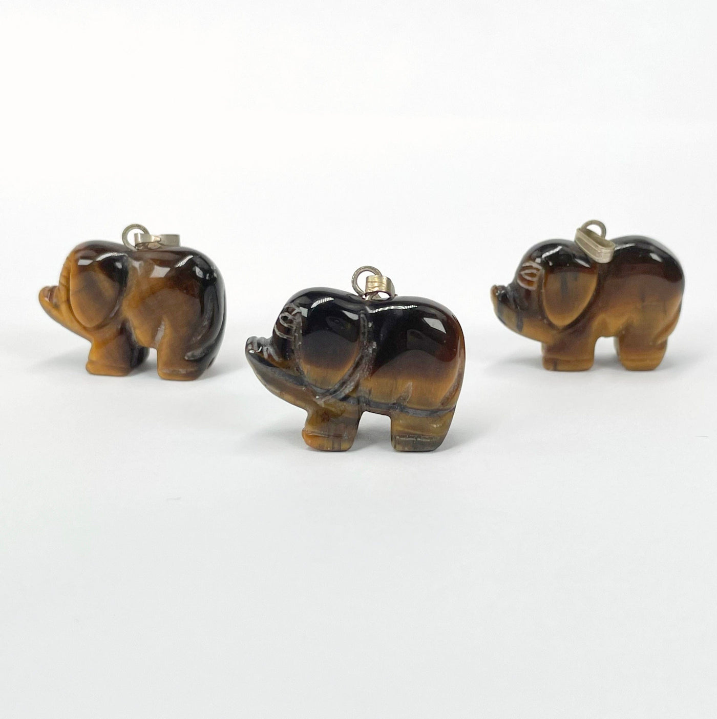 side view of tigers eye elephant pendants