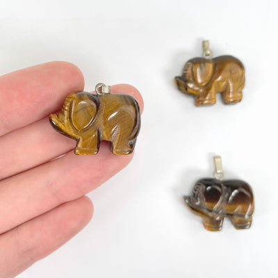 tigers eye elephant pendants in hand and on display