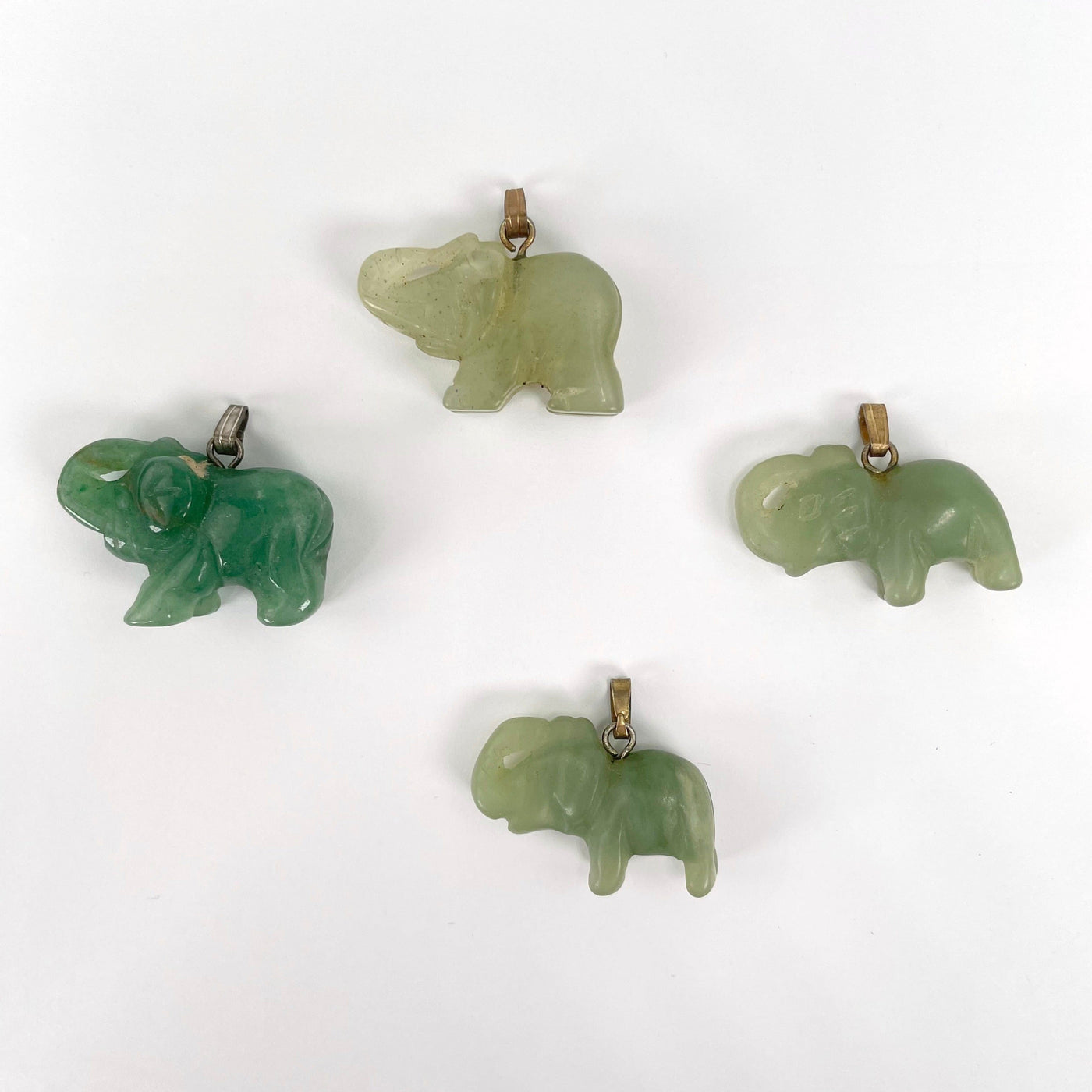 green quartz elephant pendants laying flat