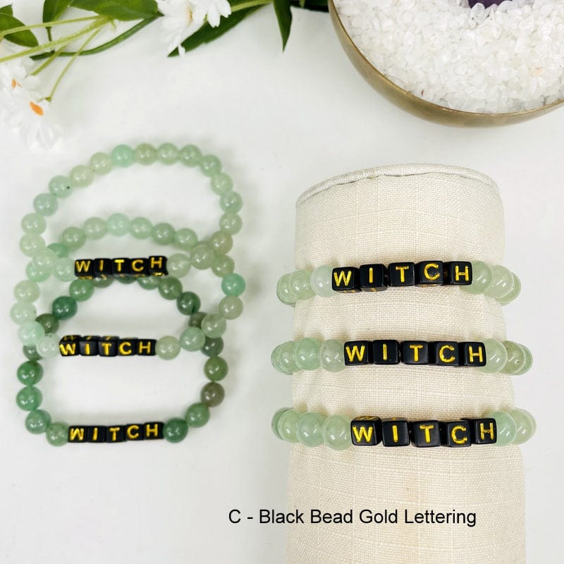 green aventurine bracelet with black beads that say WITCH in gold