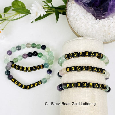 fluorite bead bracelet with black beads that spell out BOSSBABE in gold