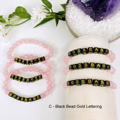 rose quartz bead bracelet with the black beads that spell out BOSSBABE in gold 