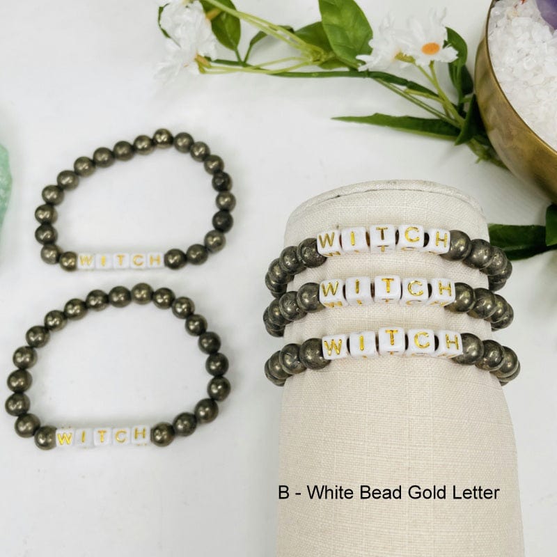 pyrite round bead bracelets with white square beads that spell out WITCH in gold
