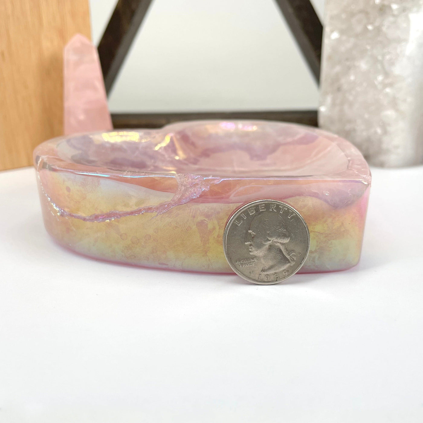 side view of angel aura rose quartz heart bowl with quarter for thickness